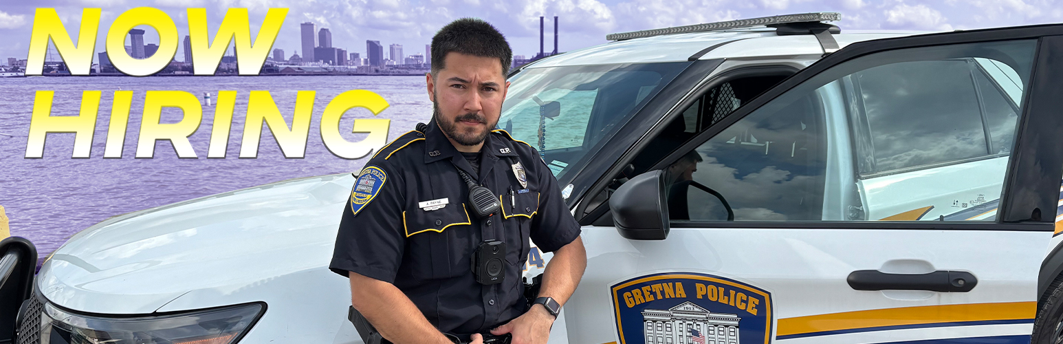 GPD Officer posing in front of his car on the Gretna Landing overlooking the Mississippi River and the Crescent City, New Orleans. 
